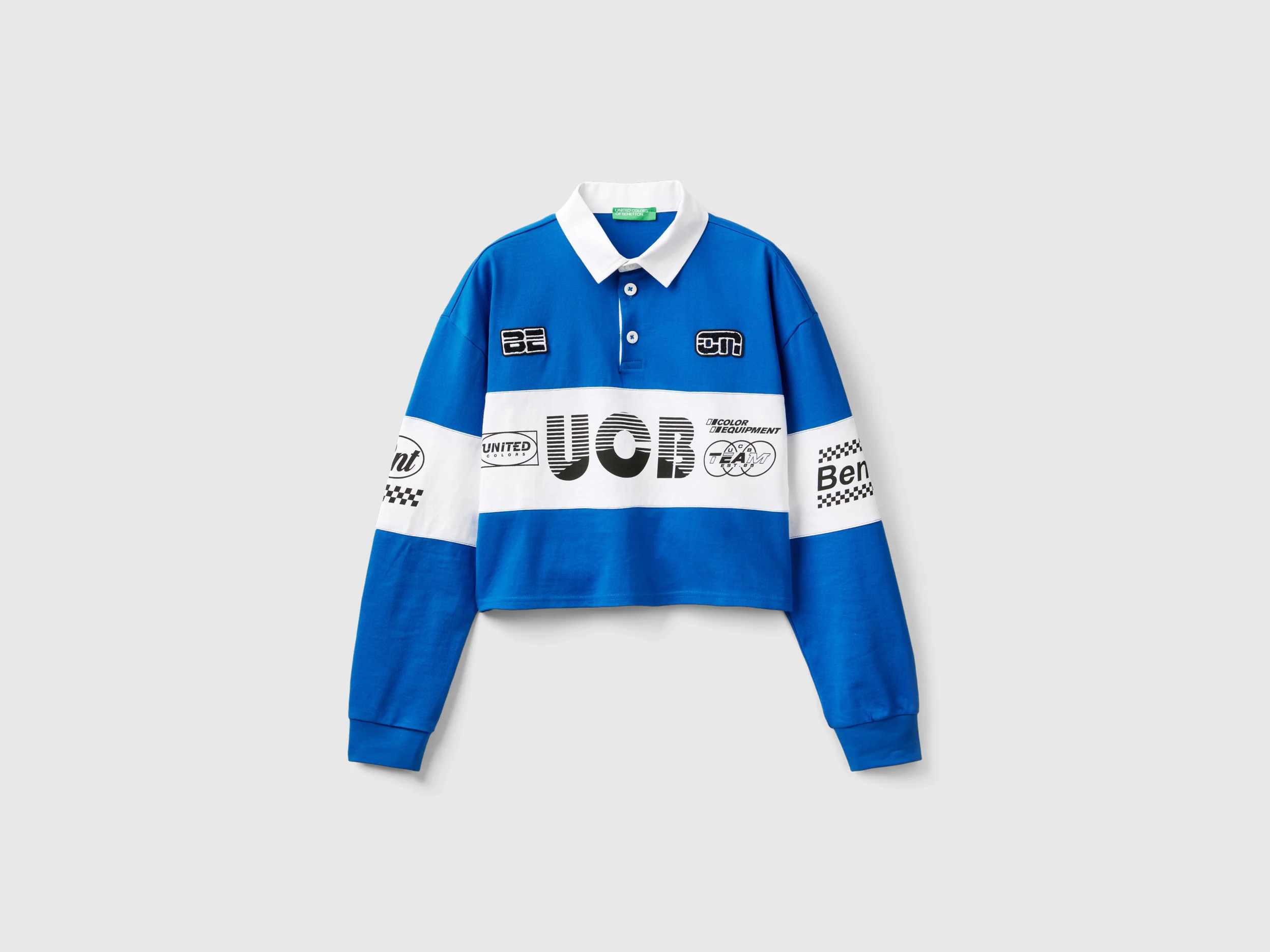 Polo cropped con patch e stampe